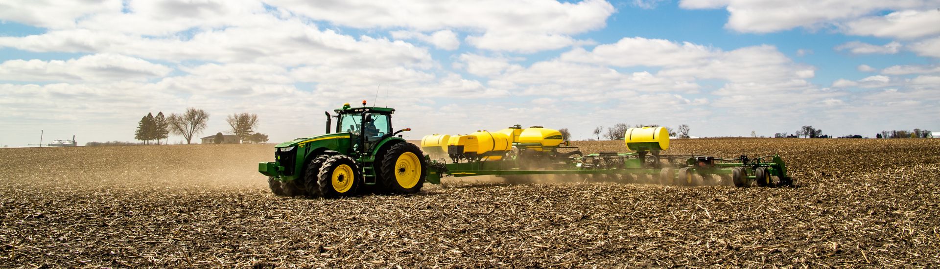 Tractor pulling planter through a field